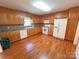 The kitchen features wood cabinets, tile backsplash, and white appliances at 904 3Rd Street Ne Pl, Conover, NC 28613