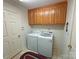 Convenient laundry area equipped with a washer, dryer, and overhead cabinets for storage at 904 3Rd Street Ne Pl, Conover, NC 28613