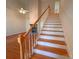 View of the staircase with hardwood steps and white risers, complemented by a wooden banister at 904 3Rd Street Ne Pl, Conover, NC 28613