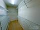 Functional walk-in closet providing ample storage space with metal shelving and tan carpeting at 904 3Rd Street Ne Pl, Conover, NC 28613