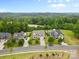 Overhead view captures lush greenery and stately homes lining a picturesque street, with a tranquil forest backdrop at 9303 Raven Top Dr, Mint Hill, NC 28227