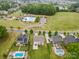 Aerial view of a community pool and playground surrounded by green spaces and residential homes at 9303 Raven Top Dr, Mint Hill, NC 28227