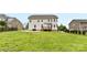 Expansive backyard featuring a patio, wooden deck, and mature trees, ideal for outdoor gatherings at 9303 Raven Top Dr, Mint Hill, NC 28227