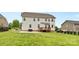 Grassy backyard with deck, patio, and privacy fence offers a perfect space for recreation and relaxation at 9303 Raven Top Dr, Mint Hill, NC 28227