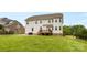 Lush backyard with a patio, deck, and mature trees, great for relaxing and entertaining outdoors at 9303 Raven Top Dr, Mint Hill, NC 28227