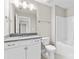Well-lit bathroom with vanity, gray countertops, and combination tub and shower at 9303 Raven Top Dr, Mint Hill, NC 28227