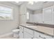 Bathroom featuring modern vanity, toilet, tile flooring, and window at 9303 Raven Top Dr, Mint Hill, NC 28227