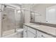 Clean bathroom featuring a walk-in shower, gray vanity, and white cabinets at 9303 Raven Top Dr, Mint Hill, NC 28227