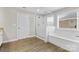 Bathroom featuring modern tub, glass shower, tile flooring, and window at 9303 Raven Top Dr, Mint Hill, NC 28227