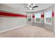 Bedroom featuring three windows, ceiling fan, red stripe, and carpet flooring at 9303 Raven Top Dr, Mint Hill, NC 28227