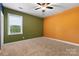 Bedroom with neutral carpet, natural light, and an accent wall at 9303 Raven Top Dr, Mint Hill, NC 28227