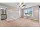 Bedroom featuring a window with natural light, ceiling fan, a stripe and carpet flooring at 9303 Raven Top Dr, Mint Hill, NC 28227