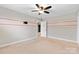 Spacious bedroom with carpet, ceiling fan, and unique wall accents, ready for personalization at 9303 Raven Top Dr, Mint Hill, NC 28227