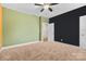 Spacious bedroom featuring neutral carpet, and a colorful accent wall at 9303 Raven Top Dr, Mint Hill, NC 28227
