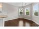 Bright breakfast nook with hardwood floors, wainscoting, and a modern chandelier at 9303 Raven Top Dr, Mint Hill, NC 28227