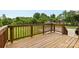 Wooden deck overlooking a well-maintained backyard with lush greenery and a basketball hoop at 9303 Raven Top Dr, Mint Hill, NC 28227