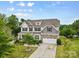 Two story home featuring a landscaped yard, large driveway, and neutral color palette at 9303 Raven Top Dr, Mint Hill, NC 28227