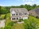 Traditional two story home showcasing a landscaped yard, covered porch, and neutral color palette at 9303 Raven Top Dr, Mint Hill, NC 28227