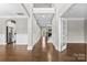 Elegant foyer with hardwood floors, wainscoting, and an open view to the staircase and living areas at 9303 Raven Top Dr, Mint Hill, NC 28227