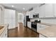 Kitchen featuring white cabinets, stainless steel appliances, and granite countertops at 9303 Raven Top Dr, Mint Hill, NC 28227