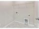 Functional laundry room featuring a utility sink and storage shelving at 9303 Raven Top Dr, Mint Hill, NC 28227