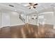 Bright living room featuring a coffered ceiling, hardwood floors, and views into the kitchen at 9303 Raven Top Dr, Mint Hill, NC 28227