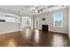 Open concept living room with hardwood floors, fireplace, and backyard deck access at 9303 Raven Top Dr, Mint Hill, NC 28227