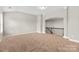 Open loft area with neutral tones and views of staircase, perfect for versatile use at 9303 Raven Top Dr, Mint Hill, NC 28227