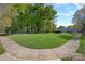 Expansive backyard with lush green grass, mature trees, and sidewalk at 9803 Tree Canopy Rd, Charlotte, NC 28277