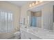 Well-lit bathroom with vanity, ample counter space, and a shower with curtain at 9803 Tree Canopy Rd, Charlotte, NC 28277