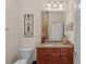Bathroom vanity featuring a granite countertop, wooden cabinets, and decorative wall accents at 9803 Tree Canopy Rd, Charlotte, NC 28277