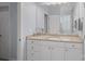 Bathroom vanity with a granite countertop, white cabinets, and large mirror, offering ample storage at 9803 Tree Canopy Rd, Charlotte, NC 28277