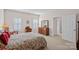 Bright bedroom with hardwood furniture, shuttered windows, and en-suite bathroom at 9803 Tree Canopy Rd, Charlotte, NC 28277