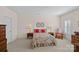 Cozy bedroom with floral bedding, wooden nightstands, and decorative wall art at 9803 Tree Canopy Rd, Charlotte, NC 28277