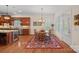Cozy dining area next to kitchen features hardwood floors, natural lighting, and a view of the outdoors at 9803 Tree Canopy Rd, Charlotte, NC 28277