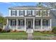Stately home with a grand front porch, columns, and manicured landscaping at 9803 Tree Canopy Rd, Charlotte, NC 28277
