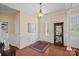 Inviting foyer with hardwood floors, wainscoting, and sophisticated decor creates a warm welcome at 9803 Tree Canopy Rd, Charlotte, NC 28277