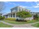 Inviting front porch with classic white pillars and a charming garden at 9803 Tree Canopy Rd, Charlotte, NC 28277
