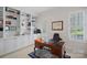 Elegant home office with custom built-ins, a classic wooden desk, and a comfortable leather chair at 9803 Tree Canopy Rd, Charlotte, NC 28277