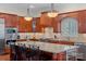 Beautiful kitchen island features granite countertops, pendant lighting, and sleek stainless steel appliances at 9803 Tree Canopy Rd, Charlotte, NC 28277