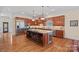 Gourmet kitchen with granite countertops, a wine cooler, stainless steel appliances, and custom wood cabinets at 9803 Tree Canopy Rd, Charlotte, NC 28277