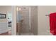 Modern glass-enclosed shower featuring neutral tile and a mounted shower head, offering a clean design at 9803 Tree Canopy Rd, Charlotte, NC 28277
