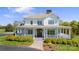Stunning home featuring a welcoming front porch, stone walkway, and beautifully manicured landscaping at 1065 Hunter Bridge Rd, Stony Point, NC 28678