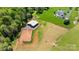 Aerial view featuring horse barn, paddock, and fenced pasture of well maintained property at 1065 Hunter Bridge Rd, Stony Point, NC 28678