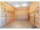 Open horse stall with wood paneling, overhead lighting, and plenty of room for horse to move at 1065 Hunter Bridge Rd, Stony Point, NC 28678