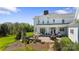 An idyllic outdoor living space with fireplace, seating, and plush landscaping at 1065 Hunter Bridge Rd, Stony Point, NC 28678