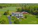 A beautiful estate featuring a manicured lawn and a classic home with a barn on a tree-lined property at 1065 Hunter Bridge Rd, Stony Point, NC 28678