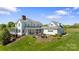 Charming rear exterior with patio, outdoor fireplace, and well manicured landscaping at 1065 Hunter Bridge Rd, Stony Point, NC 28678