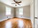 Bedroom with hardwood flooring, ceiling fan, white trim, double windows, and a closet at 109 Georgia Belle Ave # 199, Belmont, NC 28012