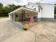 Attached carport with decorative support columns and an American flag, adding charm to the property at 109 Georgia Belle Ave # 199, Belmont, NC 28012